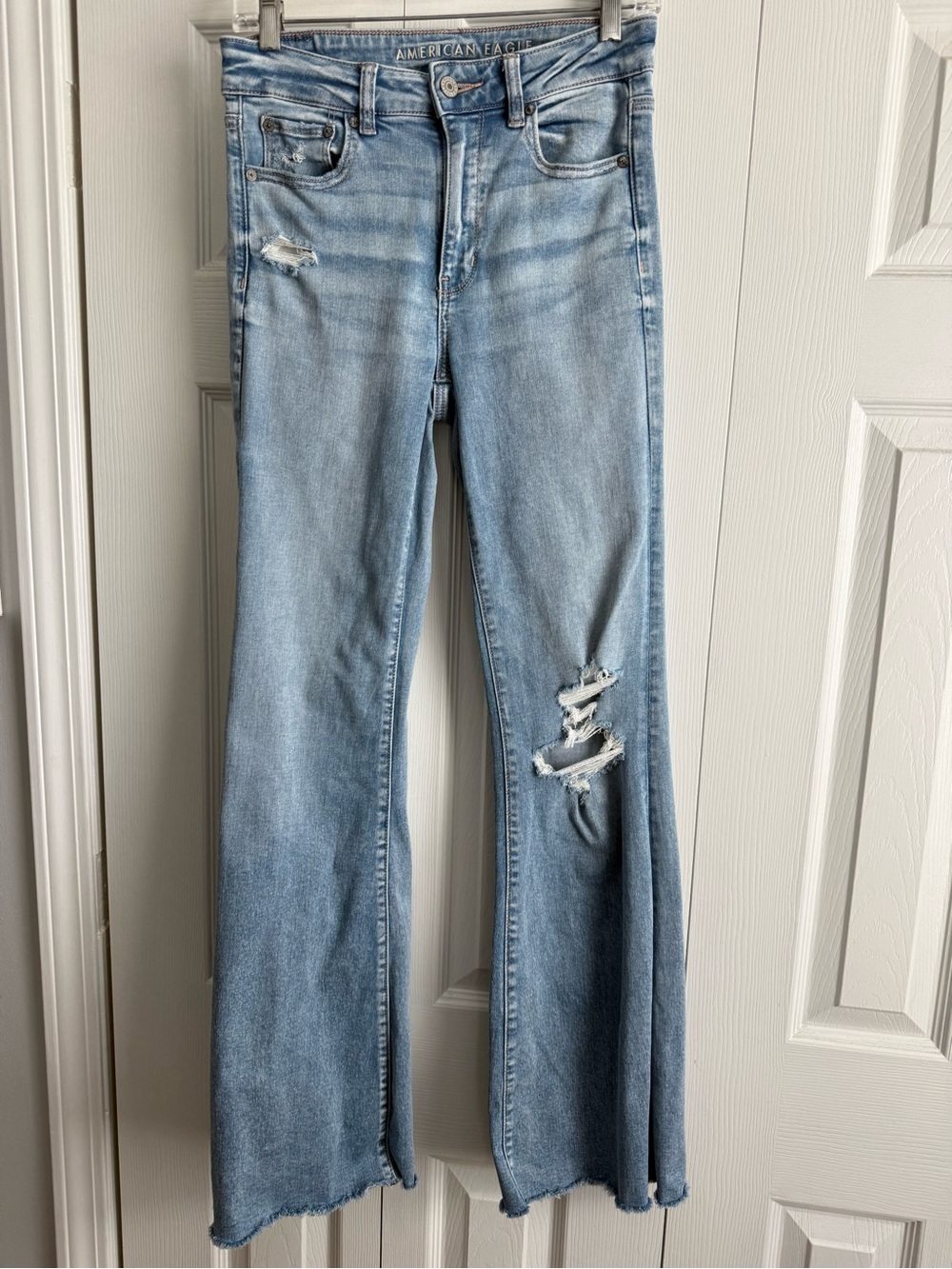 American Eagle Outfitters light wash distressed flare jeans